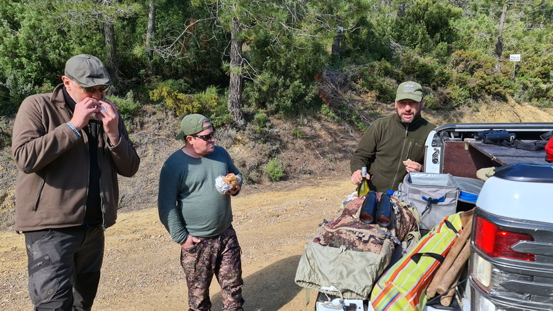 Two hunters having meal and getting ready for hunting roe deer in Spain