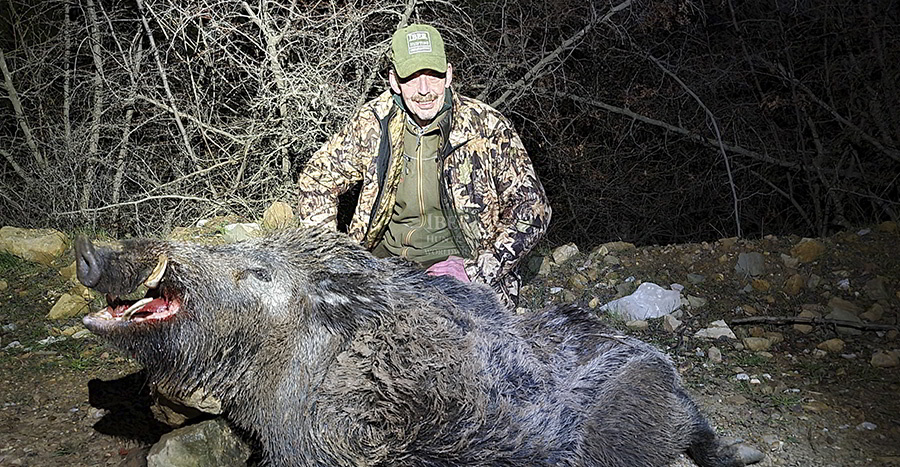 Hunter with his wild boar hunting trophy in Turkey