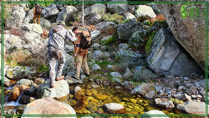 Hunters crossing the river in the Gredos hunting area