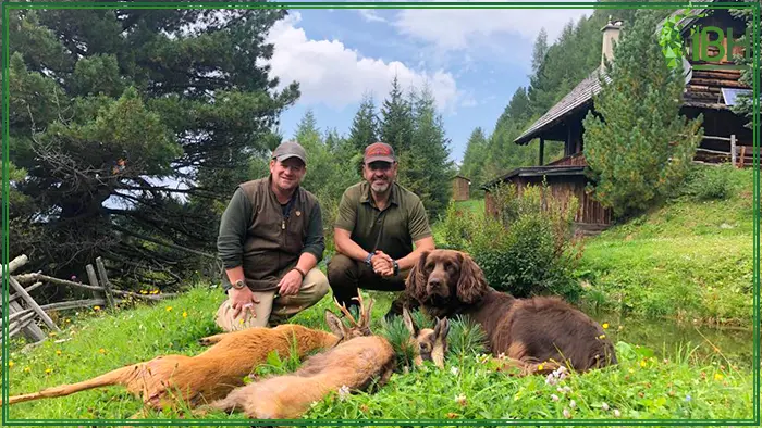 Two hunters with their hunting trophies in Austria