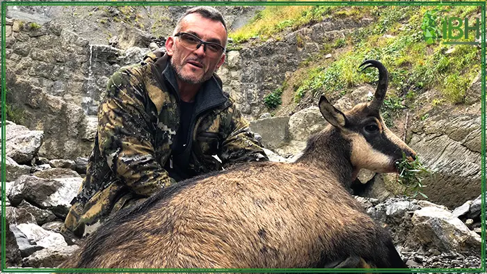 Hunter with his alpine chamois in France