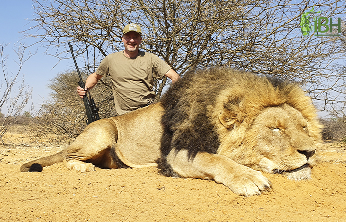 Jorg posing next to his lion trophy for big five in Africa