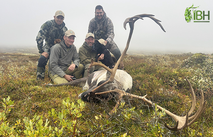 Hunters with the guides and Diva posing with the Caribou hunting trophy in Norway