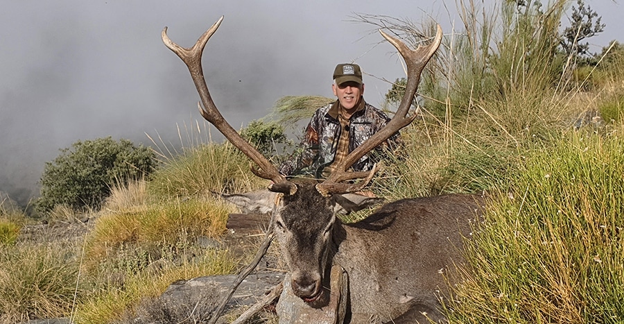 Hunter with red stag deer trophy in Spain