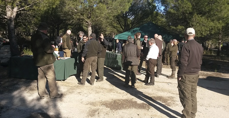 Hunters having a meal after driven hunt in Spain